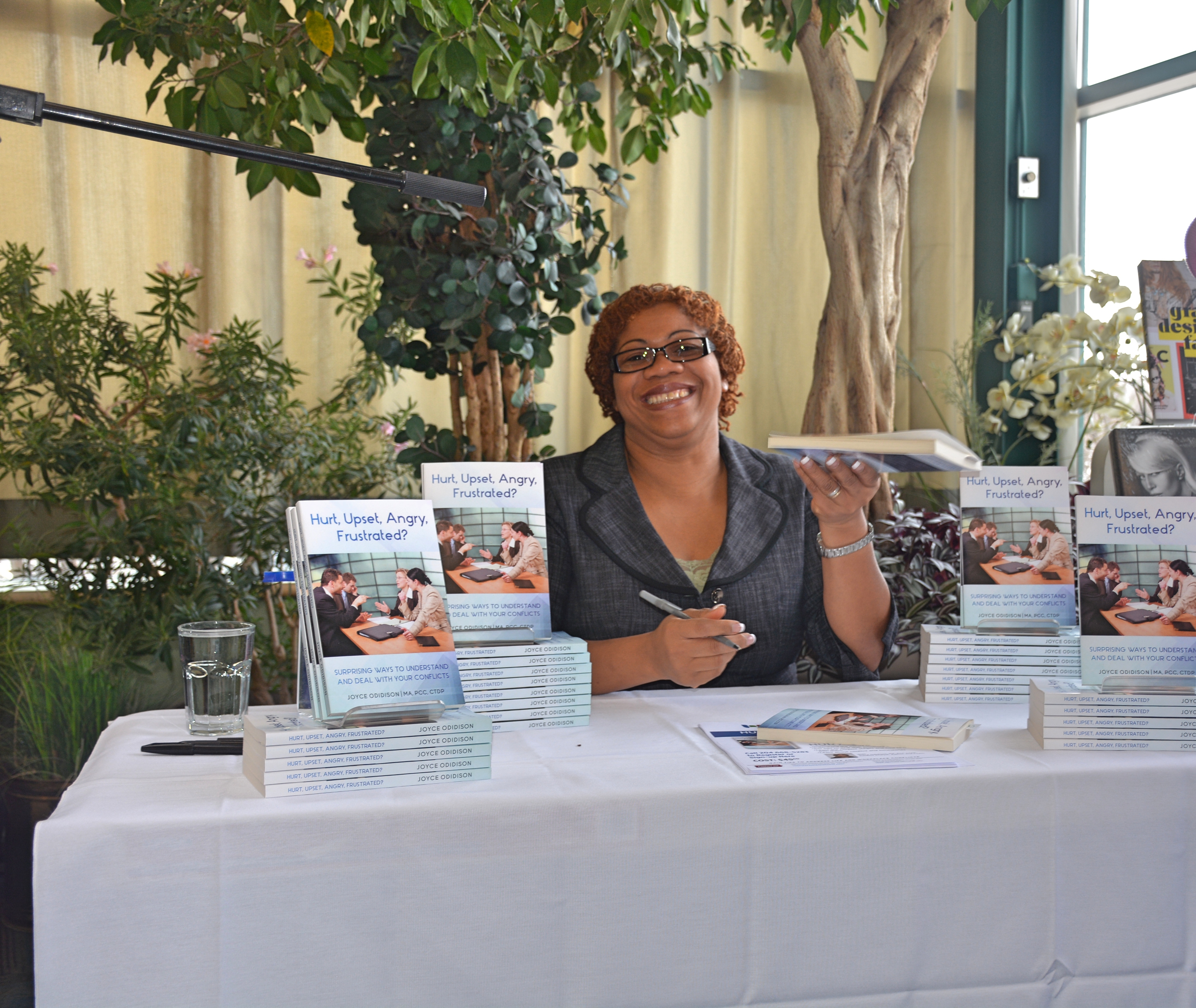 Joyce Odidison signing books, author and creator of Resilience Depletion Theory